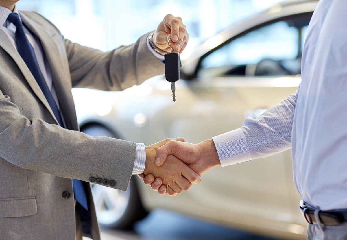 Man handing car keys to another man